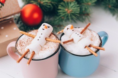 mugs with hot chocolate in which the men from the marshmallow relax. concept of a couple