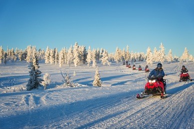 group of snowmobiles in lapland, near saariselka, finland