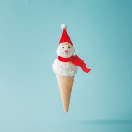 snowman made of ice cream on bright blue background. winter holiday concept.