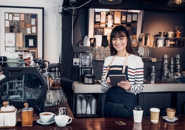 woman barista take order with tablet,asia female waitress using digital device in coffee shop business at counter bar in cafe,moder food owner business start up