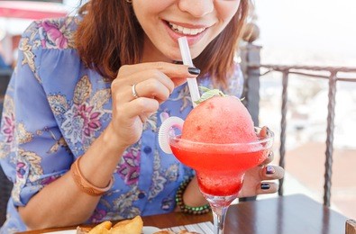 beautiful young asian woman drinking watermelon juice or smoothie at the cafe background