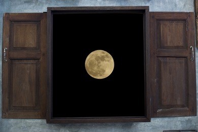 view of a moon through old grunge wooden window