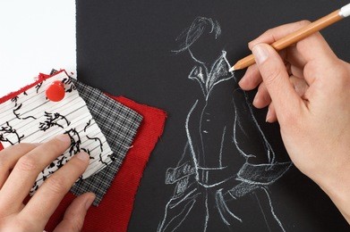 fashion designer is drawing a fashion model