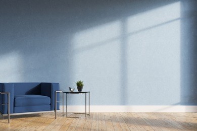 minimalistic living room interior with blue walls, a wooden floor, a soft blue and silver armchair and a tiny coffee table. 3d rendering mock up