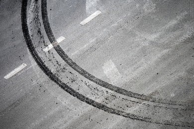 abstract road background with crossing of road marking and tires track