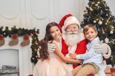 santa claus with kids indoors christmas celebration concept