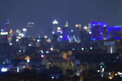 abstract background from blurred business city center light at night with bokeh and blue sky. 