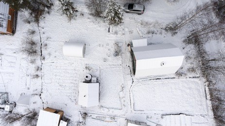 car parking near russian summer cottege covered with snow. snowy timber house and courtyard. winter is in karelia, russia