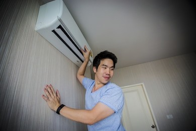 handy man cleaning the air conditioner. aa