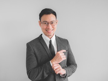 happy asian boss manager business man wears black suit in relax pose.