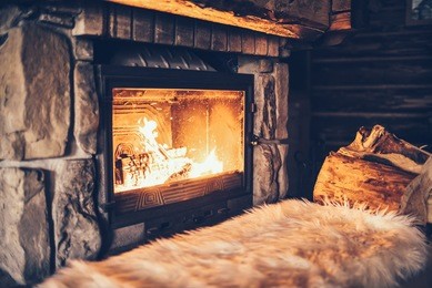 warm cozy fireplace with real wood burning in it. cozy winter concept. christmas and travel background with space for your text.