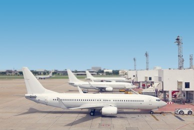 airplane loading passenger at airport gate ramp