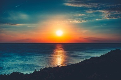sunset sky background. natural sunset sunrise over ocean. bright dramatic sky and blue water. colorful nature landscape