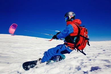 snowboarder. snowboard with snow kite against a blue sky. concept outdoor extreme activities in winter snowkite