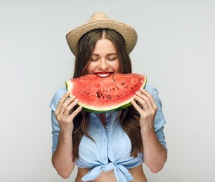 beautiful woman eating watermelon. positive portrait isolated on white.