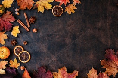 autumn background with candied oranges, nuts and spices
