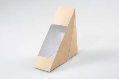 brown blank cardboard triangle take away boxes packaging for sandwich, food, gift, other products with plastic window mock up close up isolated on white background