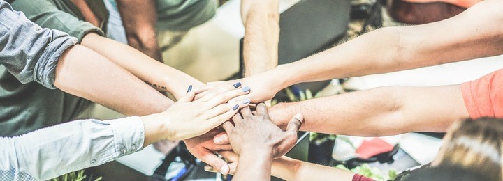 work team stacking hands together for new startup project - diverse culture people giving strength motivation to each others - focus on blue nails woman hand - power and human strongness concept