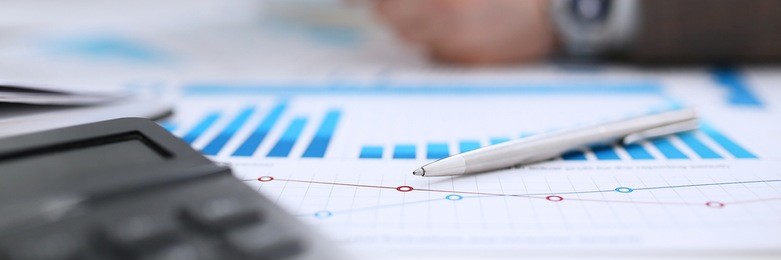 financial statistics documents ball pen infographics at office table closeup. internal revenue service inspector sum check investigation exchange market earnings savings loan and credit concept