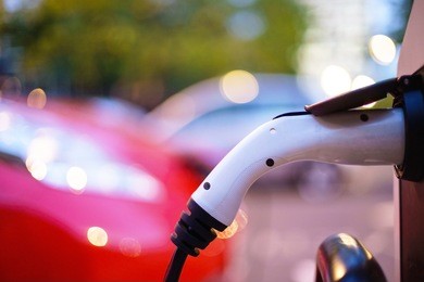 electric vehicle is changing in street.