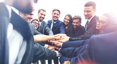 large business team showing unity with their hands together