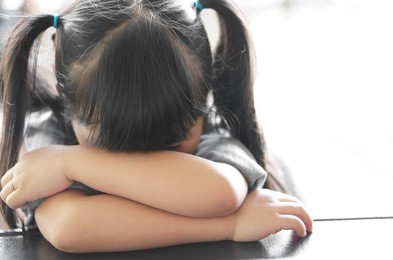 asian children cute or kid girl sleeping and cry with sad or sick on the black table at nursery or kindergarten and preschool with white space