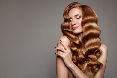 portrait of woman with long curly beautiful ginger hair.