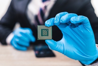 the abstract image of the business man wear a gloves and hold a cpu chip. the concept of business, technology, hardware, jobs, and electronics.