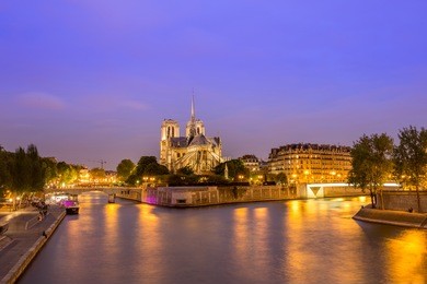 the beautiful notre dame de paris and seine river at blue hour