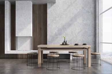 modern dining room interior with concrete and wooden walls, a wooden table with round chairs near it, a loft window and a fireplace. 3d rendering mock up