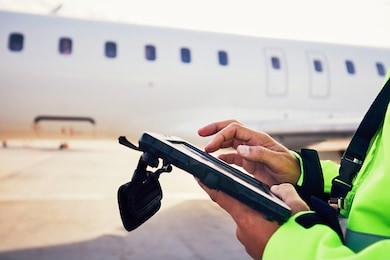 modern technology at the airport. member of the ground staff preparing the passenger airplane before flight.