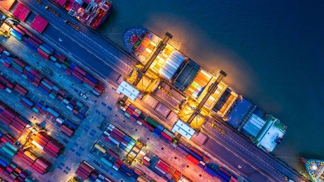 container ship in import export and business logistics, by crane, trade port, shipping cargo to harbor, aerial view from drone, international transportation, business logistics concept