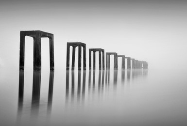 fine art image in black & white of abandon jetty at tumpat kelantan, malaysia. soft focus due to long exposure.  