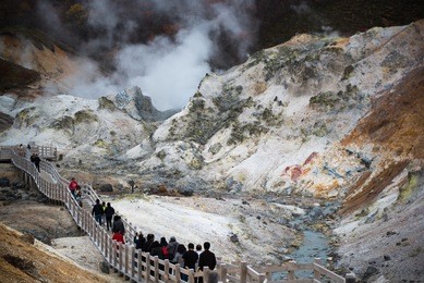 jigokudani or hell valley in the town of noboribetsu onsen, hot steam vents, sulfurous streams and other volcanic activity, hot spring waters, hokkaido, japan.