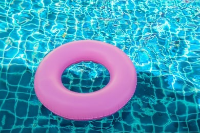 pink pool float, ring floating in a refreshing blue swimming pool
