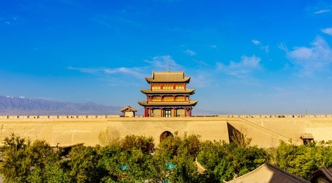 the rouyuan tower of the west barbican inner city wall of the jiayuguan fortress, which is the western-most ming great wall garrison, in the great wall of china and a blur view of tourists