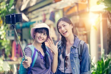 portrait of happy traveler woman selfie with friend together in city. asian women using smartphone with happy emotions, woman with travel concept. vintage tone.
