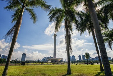 national monument viewed from the park in jakarta, indonesia