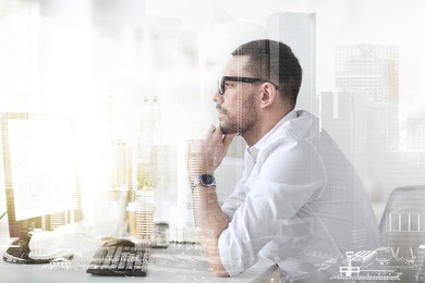 business, people and technology concept - businessman in glasses sitting at office computer and thinking with double exposure effect