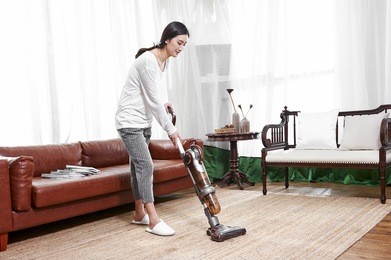 asian housewife cleaned with a vacuum cleaner