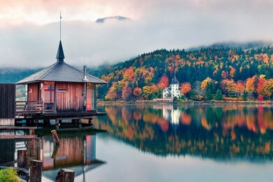 foggy autumn sunrise on grundlsee lake. amazing morning scene of brauhof village, styria stare of austria, europe. colorful view of alps. traveling concept background.