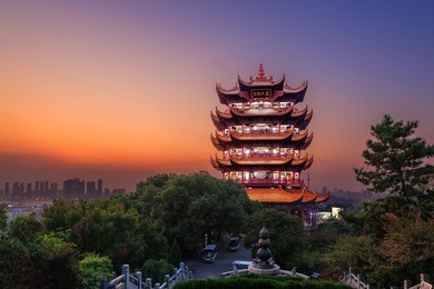 yellow crane tower at twilight, the traditional chinese multi-storey tower located on sheshan (snake hill) in wuhan, hubei, china, 4 chinese letters on tower is "mu ji tian chu" means "amazing heaven"