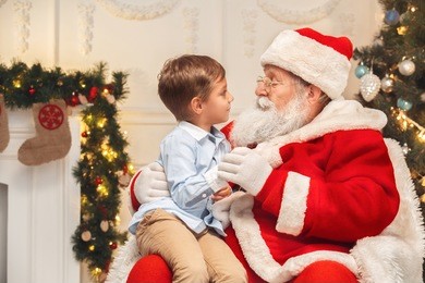 santa claus with kids indoors christmas celebration concept