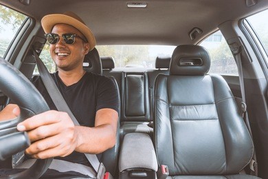 young handsome asian man driving car to travel.