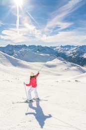young woman skier enjoying a sunny day in the snow