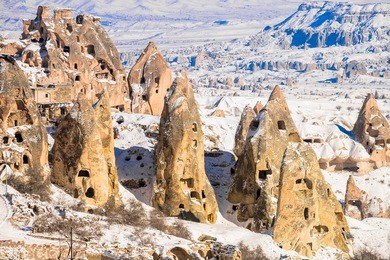 pigeon valley and cave town in goreme during winter time. cappadocia, turkey. open air museum, goreme national park. heavenly landscape
