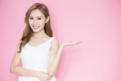 beauty skincare woman show something to you on the pink background