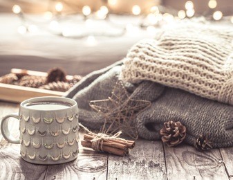 details of still life in the home interior living room. beautiful tea cup and shoes on wooden background . cosy autumn-winter concept