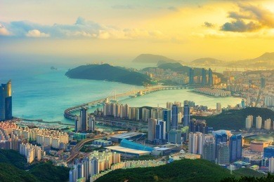 busan city, gwangan bridge and haeundae beach at sunset in south korea.