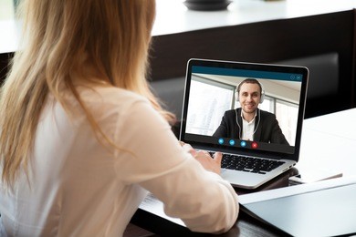 businesswoman making video call to business partner using laptop. close-up rear view of young woman having discussion with corporate client. remote job interview, consultation, human resources concept